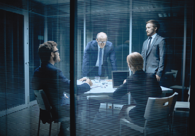 four executives in a glass office